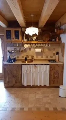 a kitchen with a sink and a counter top at Chalet-Tabià al Sol montagna Dolomiti Pecol in San Tomaso