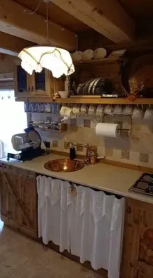 a kitchen with a sink and a counter top at Chalet-Tabià al Sol montagna Dolomiti Pecol in San Tomaso