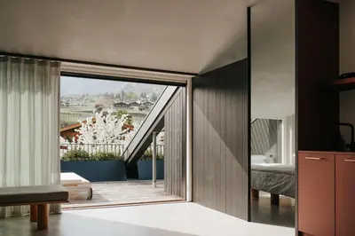 a bedroom with a sliding glass door to a balcony at chez mone&harry in Lagundo