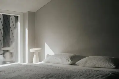 a bed with two pillows in a bedroom with a window at chez mone&harry in Lagundo