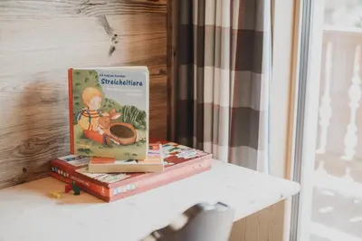 a book sitting on top of a table at Ragitt Stodl Ferienwohnungen in Vols am Schlern