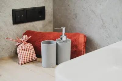 a bathroom with a sink and a red towel at Ragitt Stodl Ferienwohnungen in Vols am Schlern