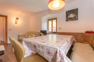 a dining room with a table and chairs at Appartamento Sant Antonio in Canale dʼAgordo