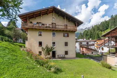 a building with a balcony on top of it at Appartamento Sant Antonio in Canale dʼAgordo