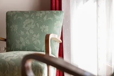 a chair in a room with a window at Apartment Sybille in Merano