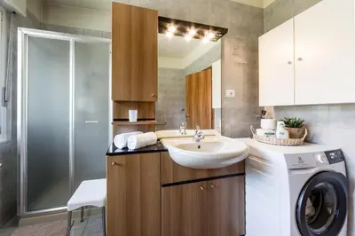a bathroom with a sink and a washing machine at Apartment Sybille in Merano