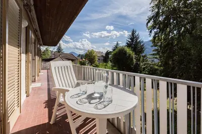 a white table and chairs on a balcony at Apartment Sybille in Merano