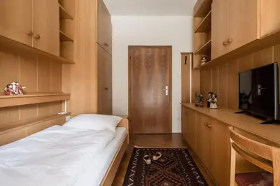 a bedroom with a bed and a flat screen tv at Apartment Sybille in Merano