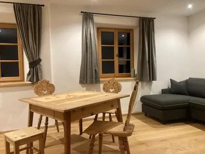 a living room with a table and a couch at Landhaus Breitenberg in Lana