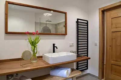 a bathroom with a white sink and a mirror at Landhaus Breitenberg in Lana
