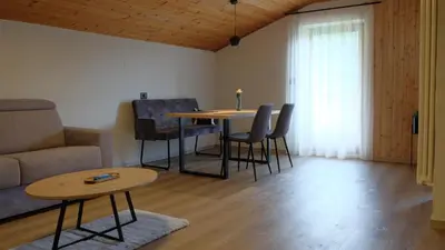 a living room with a table and chairs and a couch at Grimmhof in Fiè