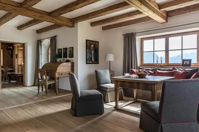 a living room with a couch and a table and a piano at Chalet Sophie in Longomoso