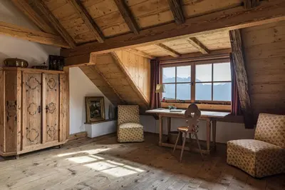 a room with a desk and chairs and a window at Chalet Sophie in Longomoso
