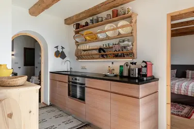 a kitchen with wooden cabinets and a counter top at Chalet Sophie in Longomoso