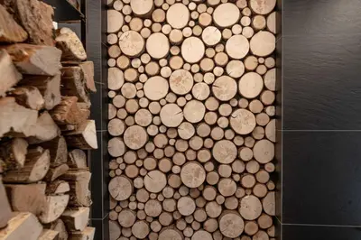 a pile of wood on a wall next to a pile of logs at Chalet Laugenblick Alpine Luxury with Hot Tub and Sauna in Santa Valburga St. Walburg