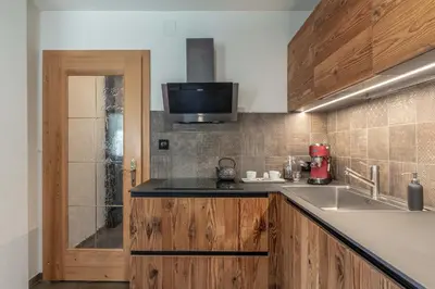 a kitchen with a sink and a counter top at Chalet Laugenblick Alpine Luxury with Hot Tub and Sauna in Santa Valburga St. Walburg