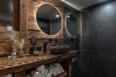 a bathroom with a sink and a mirror at Chalet Laugenblick Alpine Luxury with Hot Tub and Sauna in Santa Valburga St. Walburg