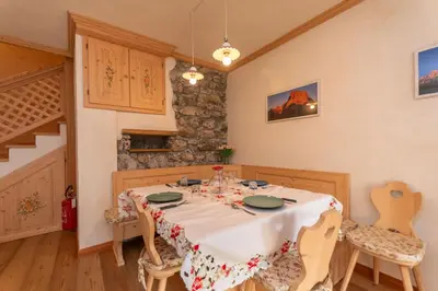 a dining room with a table and chairs at Chalet Lagusello in Alleghe