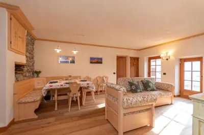 a living room with a couch and a table at Chalet Lagusello in Alleghe