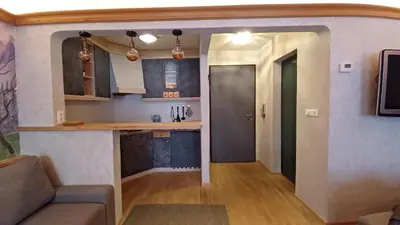 a kitchen and a living room with a couch and a table at Valentino Apartment in Castelrotto