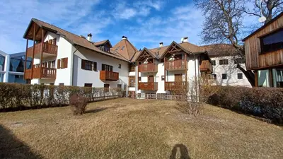 a large house with a yard in front of it at Valentino Apartment in Castelrotto