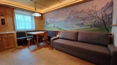 a living room with a couch and a table at Valentino Apartment in Castelrotto
