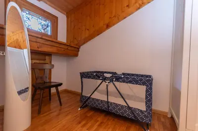 a room with a surfboard in the corner of a room at Casa Fagher in Canale dʼAgordo
