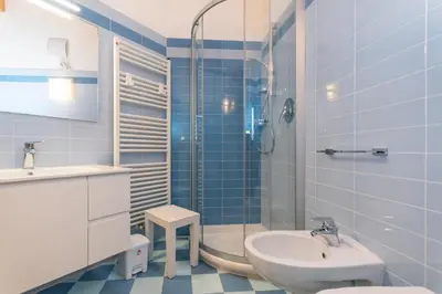 a bathroom with a shower and a sink and a toilet at Casa Milena in Pozza di Fassa