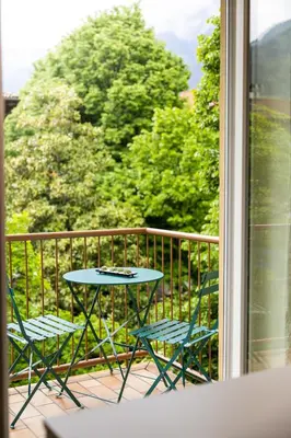a table and two chairs on a balcony at Italyescapes Delia in Merano