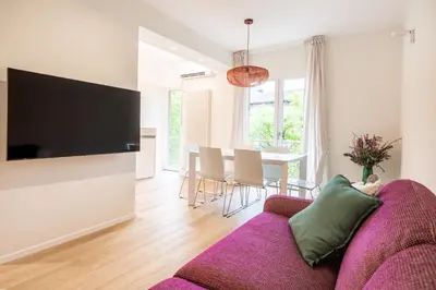 a living room with a purple couch and a table at Italyescapes Delia in Merano