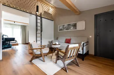 a living room with a couch and a table and chairs at Michlhaus nature and suites in Aldino