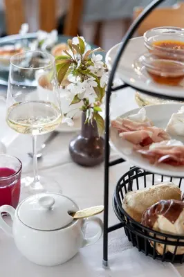 a table with plates of food and a glass of wine at Michlhaus nature and suites in Aldino
