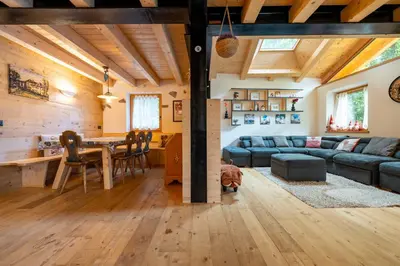 a living room with a couch and a table at Ciasa Marta in Vigo di Fassa