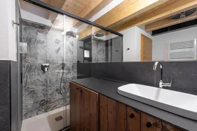 a bathroom with a sink and a shower at Ciasa Marta in Vigo di Fassa