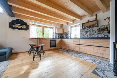 a kitchen with a table and chairs in a room at Ciasa Marta in Vigo di Fassa