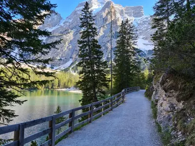 a path next to a lake with a mountain at Casa dei sogni in Valdaora