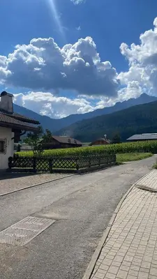 an empty road with a fence in front of a vineyard at Casa dei sogni in Valdaora