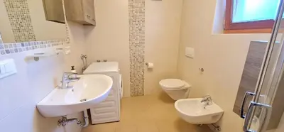 a bathroom with a sink and a toilet at Casa dei sogni in Valdaora