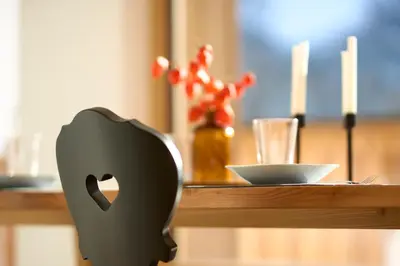 a table with a black object on a counter with a bowl at Ciasa Plandros Apartments in La Valle