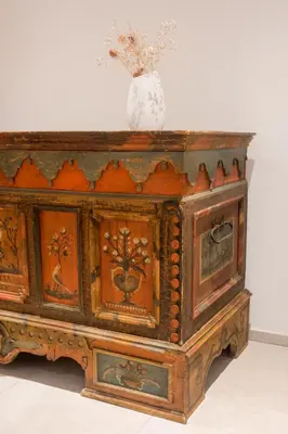 a wooden cabinet with a vase on top of it at Ciasa Plandros Apartments in La Valle