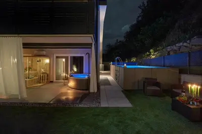 a dining room with a table and chairs with lights at Garden e Wellness LE VIGNE - relax e luxus in Tesimo