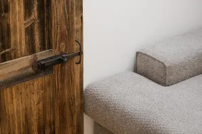 a door to a bedroom with a bed in a room at Apartsuites Rosengarten in Lagundo