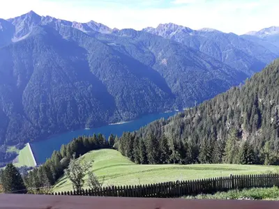 a view of a mountain range with a lake at Urlaub auf dem Bergbauernhof Gigglhirn in Ulten in Ultimo
