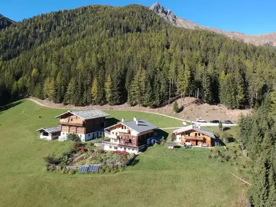 an aerial view of a house in the mountains at Urlaub auf dem Bergbauernhof Gigglhirn in Ulten in Ultimo