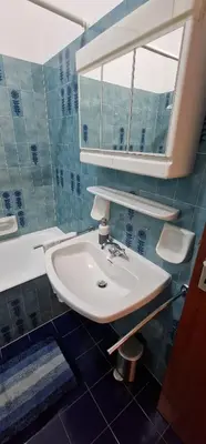 a bathroom with a sink and a mirror at Apartment Geranie - Alpstay in Naturno