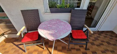 a table and two chairs with a table and a table and chairsuggest at Apartment Geranie - Alpstay in Naturno