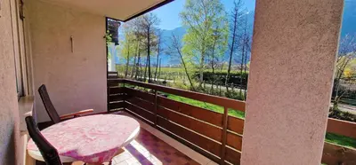 a balcony with a table and chairs and a large window at Apartment Geranie - Alpstay in Naturno