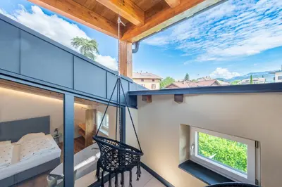 a balcony with a swing and a window at Appartments DAS Hubertus in Termeno