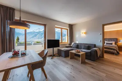 a living room with a couch and a table at Charming Suite by Dornsberg Panoramic Apartments in Schenna