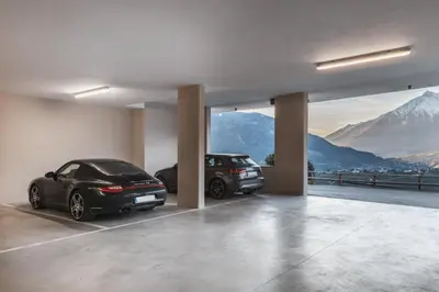 two cars parked in a garage with a view of mountains at Charming Suite by Dornsberg Panoramic Apartments in Schenna